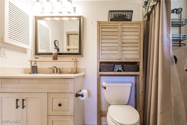 bathroom with toilet and vanity