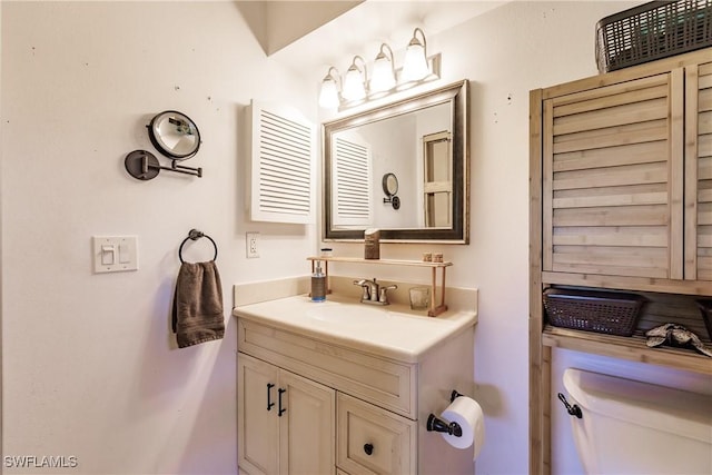 bathroom with toilet and vanity