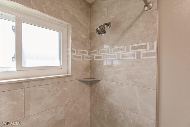 interior details featuring a tile shower