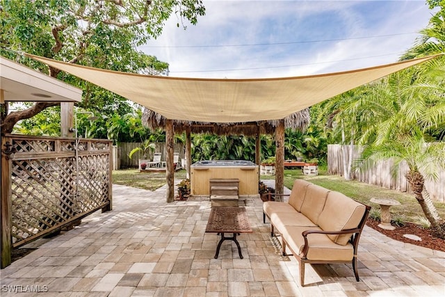 view of patio featuring a hot tub and outdoor lounge area