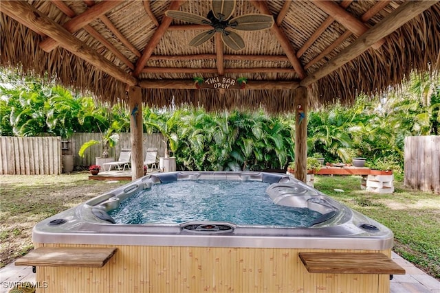 view of swimming pool with a gazebo, grilling area, ceiling fan, and a hot tub