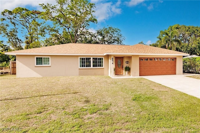 single story home with a garage and a front lawn