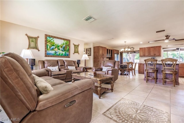 living room featuring ceiling fan with notable chandelier and light tile patterned flooring