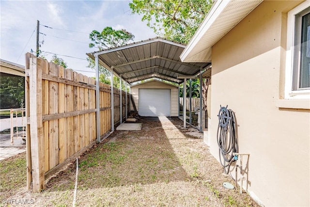 exterior space with a carport and an outdoor structure