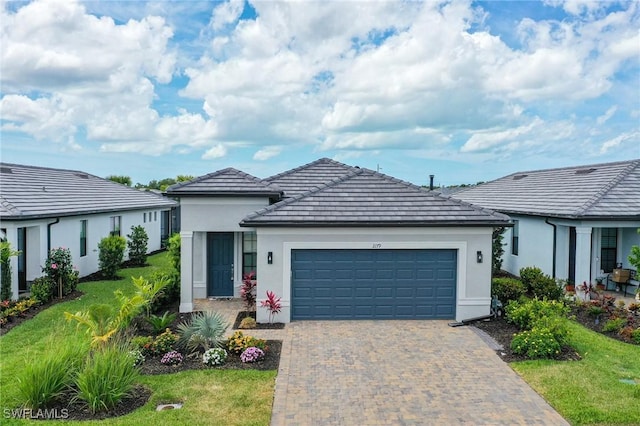 ranch-style home with a front yard and a garage