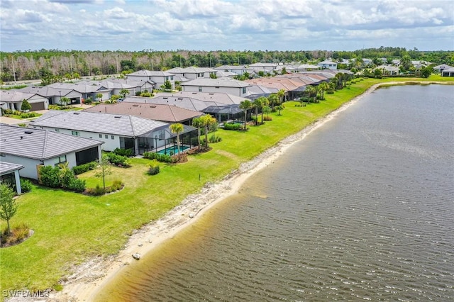 birds eye view of property featuring a water view and a beach view