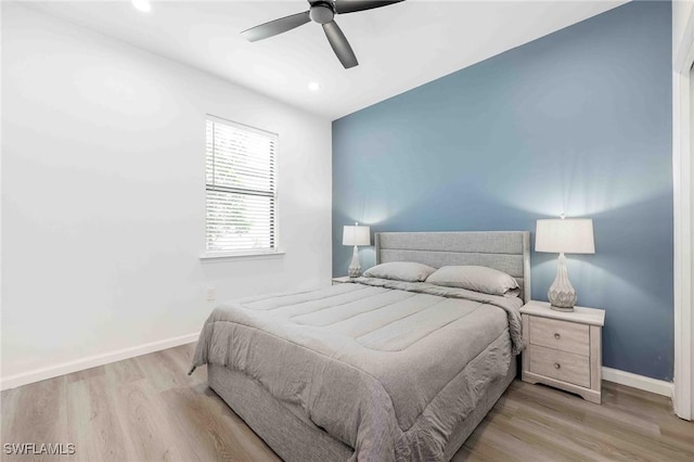 bedroom featuring light hardwood / wood-style flooring and ceiling fan