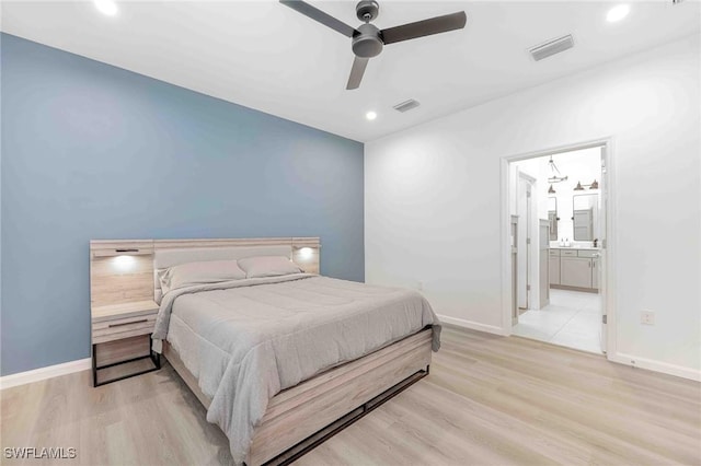 bedroom with ceiling fan, light hardwood / wood-style floors, and connected bathroom