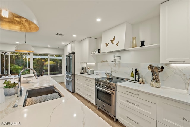 kitchen featuring white cabinets, pendant lighting, and high end appliances