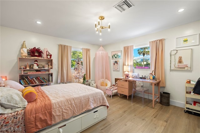 bedroom featuring a chandelier and light hardwood / wood-style floors