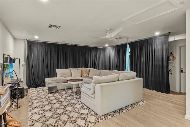 living room featuring light wood-type flooring and ceiling fan