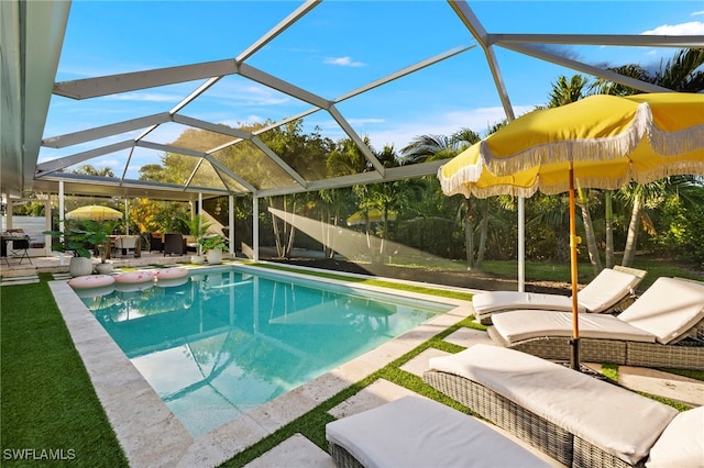 view of pool featuring glass enclosure and a patio