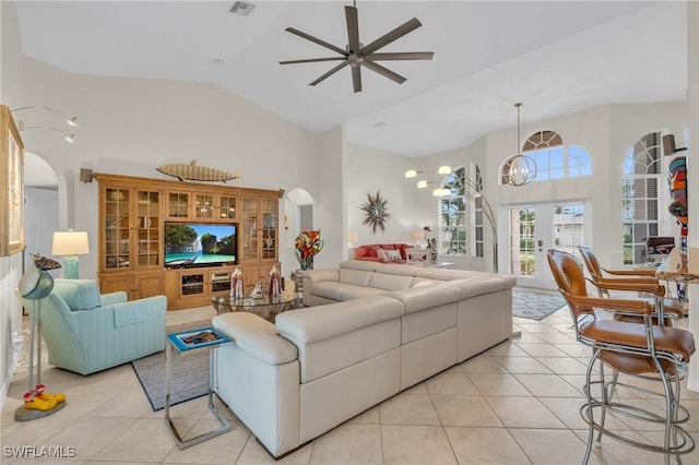 living room featuring ceiling fan, light tile patterned flooring, high vaulted ceiling, and french doors