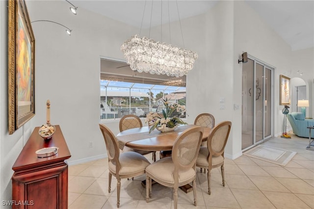 tiled dining area featuring lofted ceiling and a notable chandelier