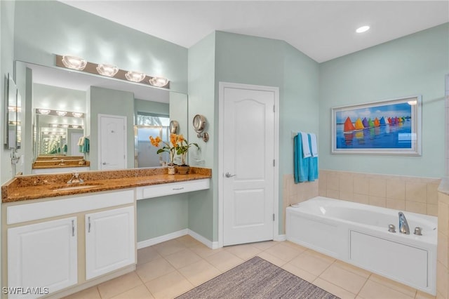 bathroom with vanity, a tub to relax in, and tile patterned floors