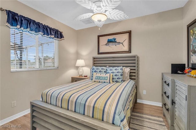 bedroom with ceiling fan and light hardwood / wood-style flooring