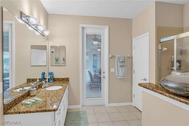 bathroom featuring tile patterned flooring, vanity, and a shower with door