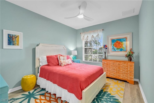 bedroom with ceiling fan and hardwood / wood-style floors