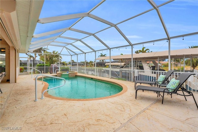 view of swimming pool with a patio area, a lanai, and an in ground hot tub