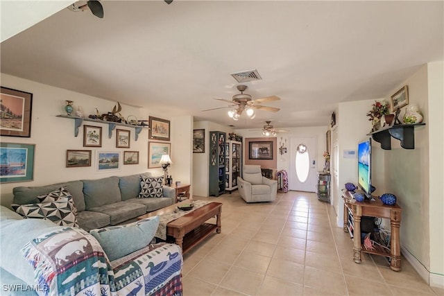 living room with ceiling fan and light tile patterned flooring