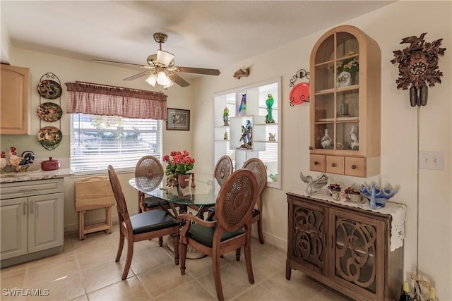 tiled dining room with ceiling fan