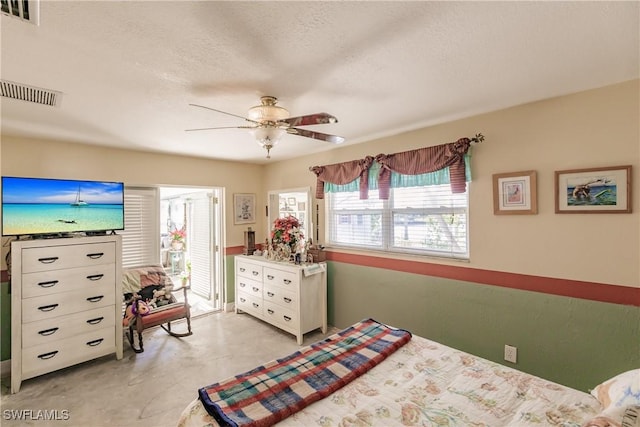 bedroom with a textured ceiling and ceiling fan