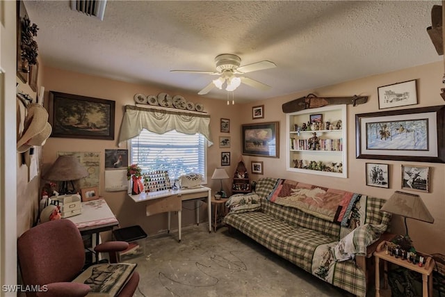 living area featuring a textured ceiling, ceiling fan, and concrete floors