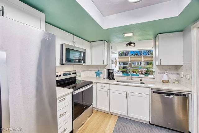 kitchen with white cabinets, sink, and stainless steel appliances