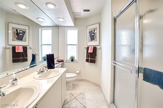 bathroom featuring tile patterned flooring, vanity, an enclosed shower, and toilet