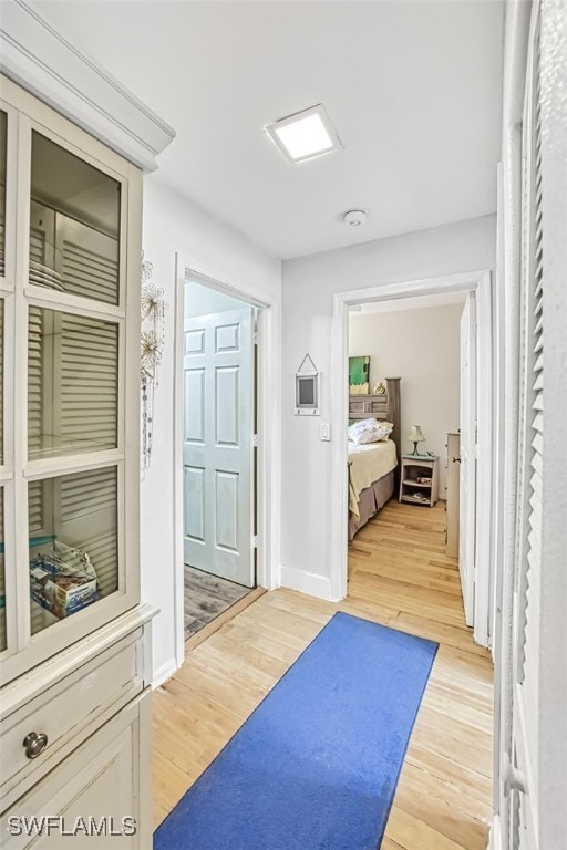 corridor with hardwood / wood-style flooring