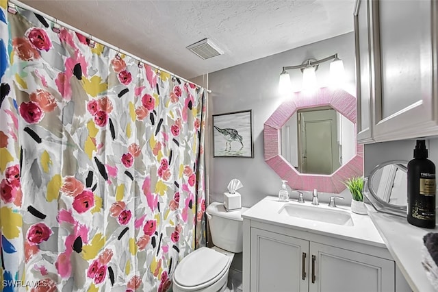 bathroom featuring vanity, curtained shower, toilet, and a textured ceiling