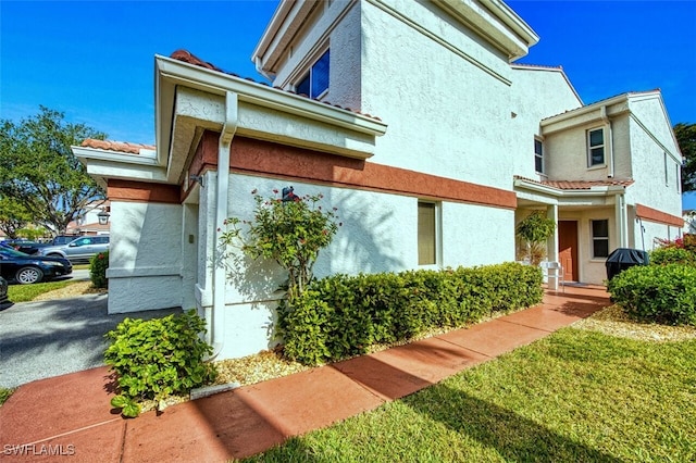 view of side of home with a lawn