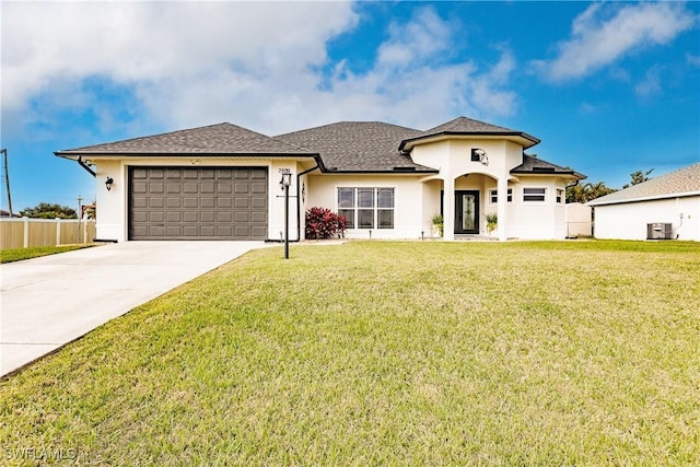 view of front of home with a front yard, a garage, and central air condition unit