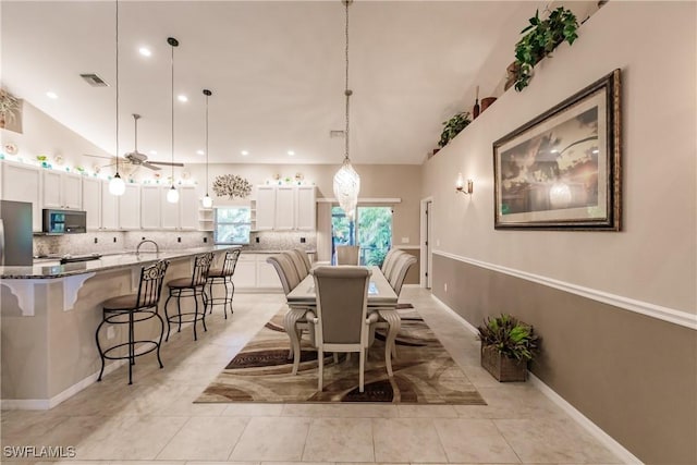 dining space featuring light tile patterned floors and ceiling fan