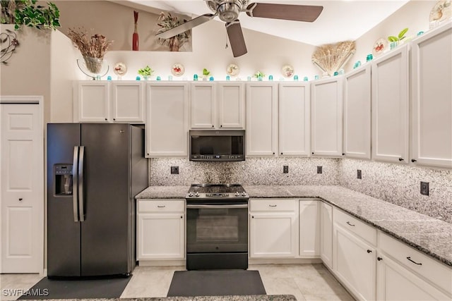 kitchen featuring white cabinets, light stone countertops, stainless steel appliances, and tasteful backsplash