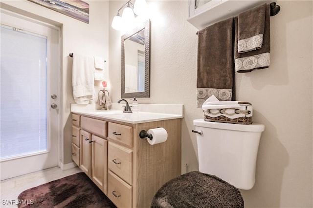 bathroom with tile patterned floors, vanity, and toilet