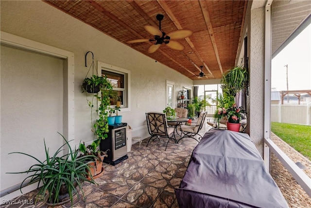 view of patio / terrace featuring ceiling fan and beverage cooler