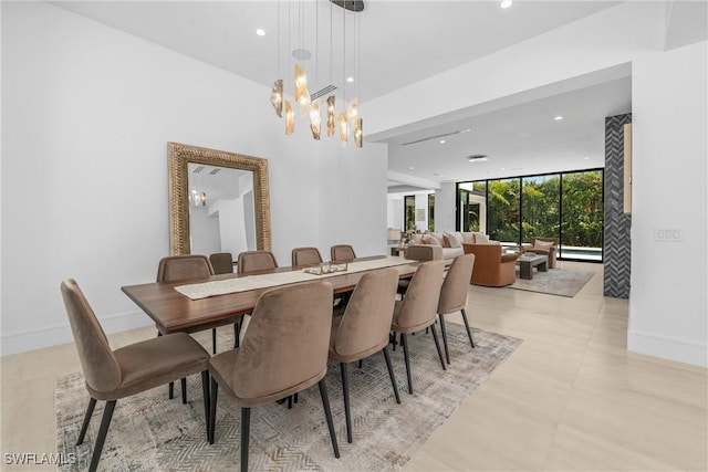 dining room featuring baseboards, visible vents, recessed lighting, a wall of windows, and a notable chandelier