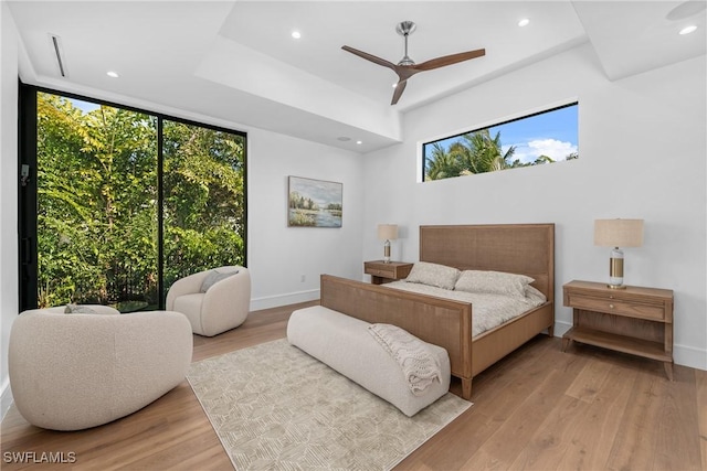 bedroom featuring wood finished floors, baseboards, and recessed lighting