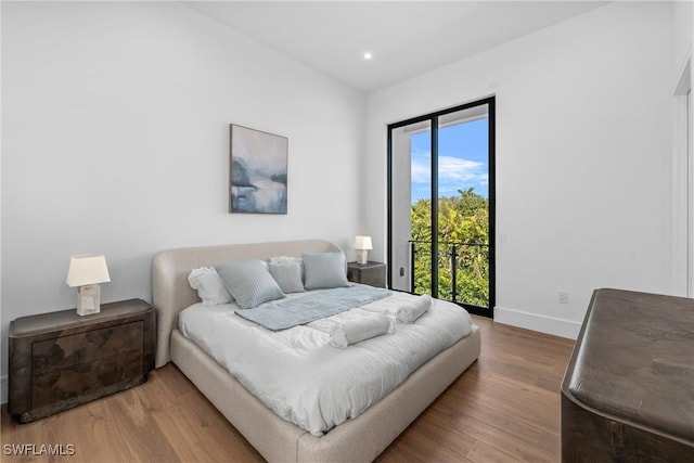 bedroom featuring baseboards, access to outside, recessed lighting, and wood finished floors
