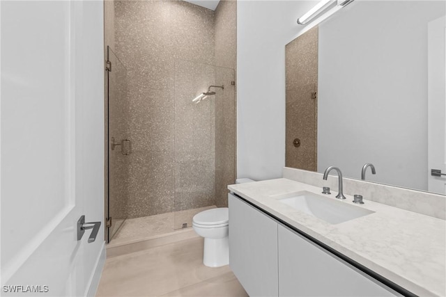 full bathroom featuring vanity, toilet, tile patterned flooring, and a shower stall