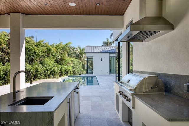 view of patio with a grill, an outdoor kitchen, an outdoor pool, and a sink
