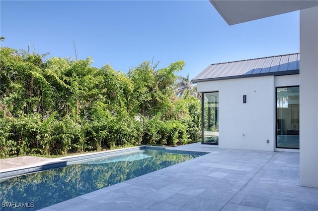 outdoor pool with a patio area