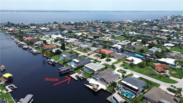 birds eye view of property with a water view