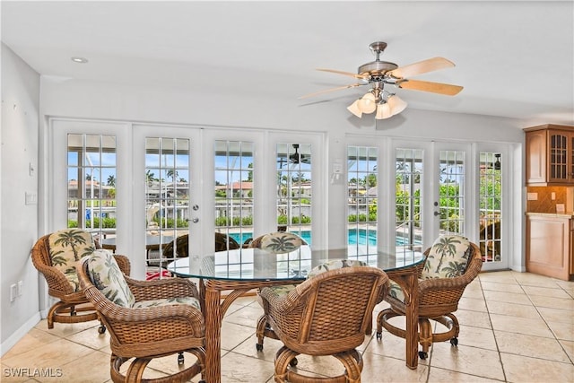 sunroom / solarium with ceiling fan and french doors