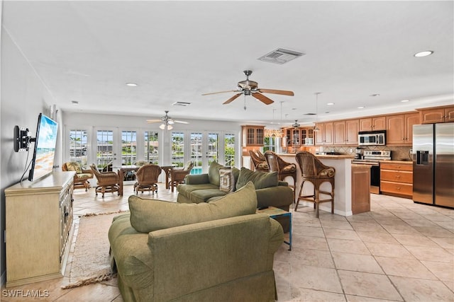 living room with ceiling fan and light tile patterned floors