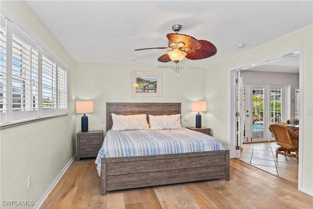 bedroom featuring ceiling fan, light hardwood / wood-style floors, and access to exterior