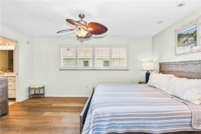 bedroom with ensuite bath, ceiling fan, light hardwood / wood-style flooring, and multiple windows