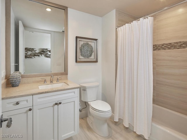 full bathroom featuring shower / bath combo with shower curtain, vanity, and toilet