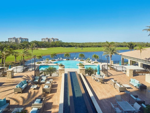 view of swimming pool featuring a grill and a water view